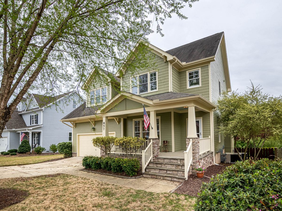 Two-story American Foursquare home with a covered front porch